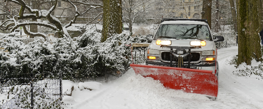 Pick up truck with plow in snow